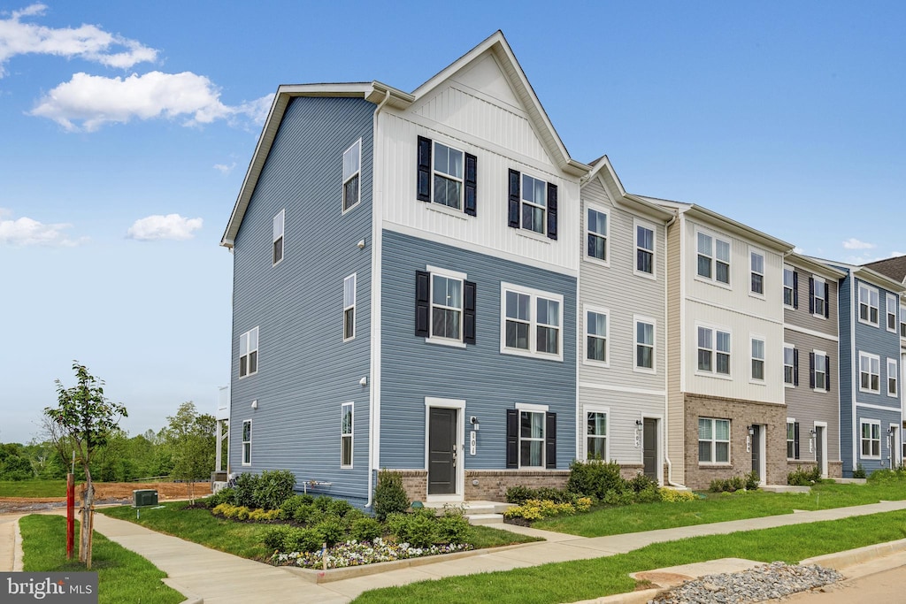 townhome / multi-family property featuring central AC unit and board and batten siding