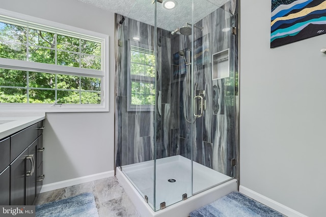 bathroom with baseboards and a stall shower