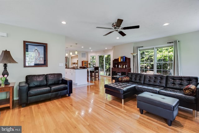 living area featuring ceiling fan, recessed lighting, and light wood-style flooring