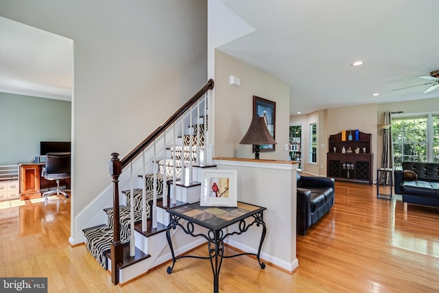 stairs with baseboards, recessed lighting, and wood finished floors