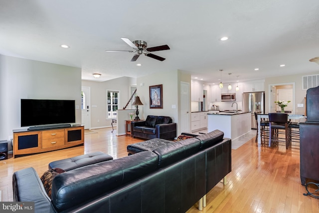 living area featuring recessed lighting, ceiling fan, visible vents, and light wood-style flooring