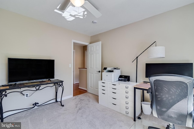 home office with baseboards, carpet, and a ceiling fan