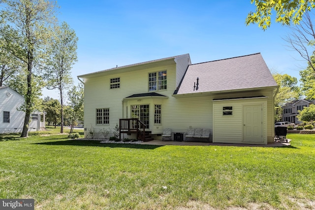 back of house with a lawn, crawl space, and roof with shingles
