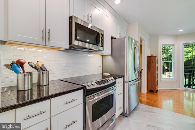 kitchen with recessed lighting, dark stone counters, backsplash, and stainless steel appliances