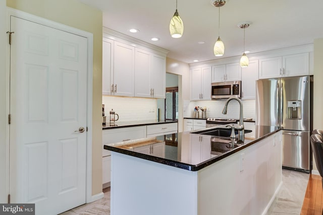 kitchen featuring backsplash, dark countertops, stainless steel appliances, recessed lighting, and white cabinetry