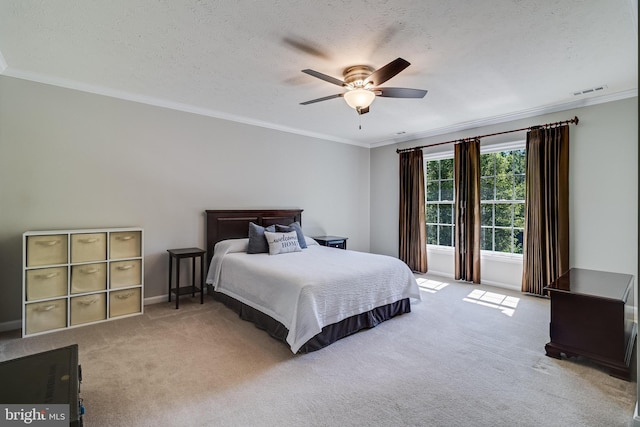 carpeted bedroom with crown molding, baseboards, a ceiling fan, and visible vents