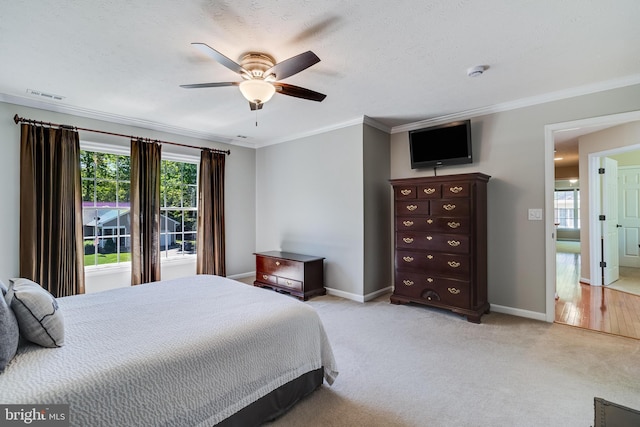 bedroom featuring baseboards, ornamental molding, multiple windows, and visible vents