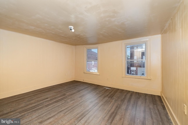 1228 Derry St, Harrisburg, PA 17104 - spare room with baseboards and dark wood-style flooring