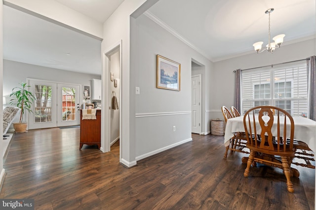 dining space with an inviting chandelier, baseboards, crown molding, and dark wood-style flooring