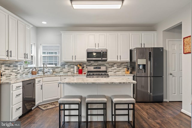 kitchen with white cabinetry, appliances with stainless steel finishes, and a sink