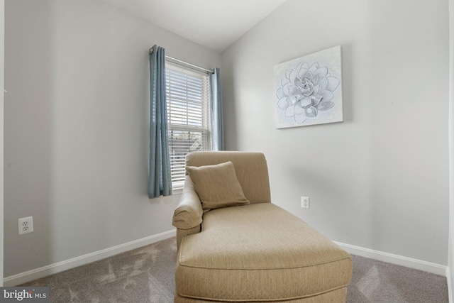 living area with baseboards and carpet