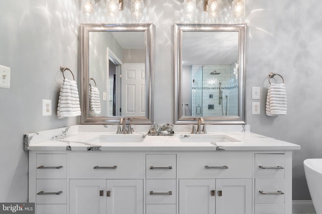 bathroom featuring double vanity, a sink, and a stall shower