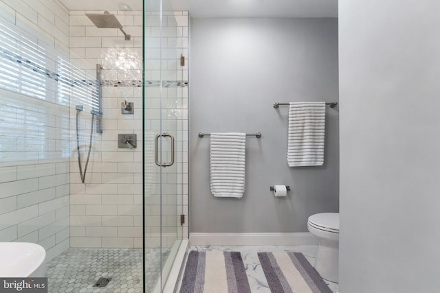 full bath featuring baseboards, a shower stall, toilet, and marble finish floor