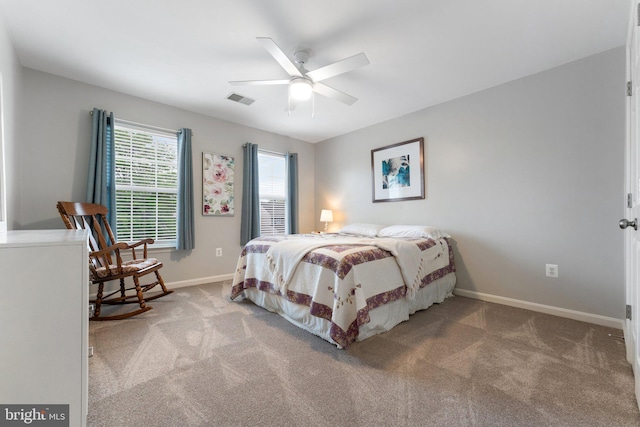 carpeted bedroom with a ceiling fan, baseboards, and visible vents