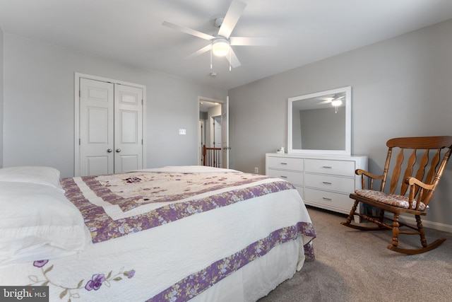 bedroom with a closet, a ceiling fan, baseboards, and dark colored carpet