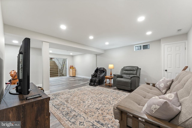 living room featuring visible vents, stairway, baseboards, recessed lighting, and light wood-style flooring