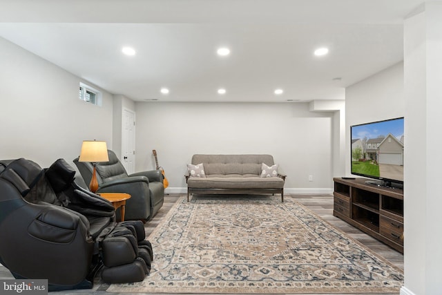 living area with recessed lighting, baseboards, and wood finished floors