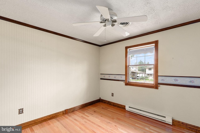 unfurnished room with a ceiling fan, a textured ceiling, light wood-type flooring, a baseboard heating unit, and ornamental molding