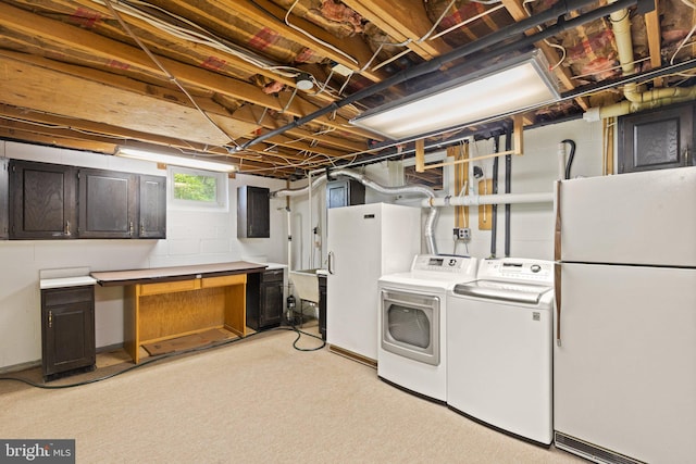 clothes washing area with light colored carpet and washer and clothes dryer