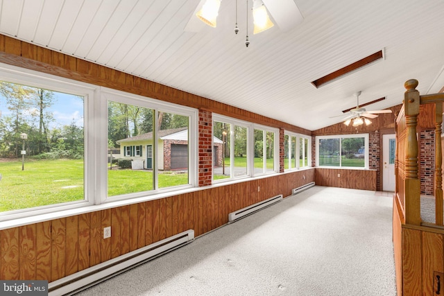 unfurnished sunroom featuring wooden walls, ceiling fan, and baseboard heating