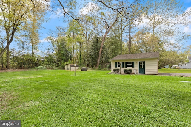 view of yard with a shed and an outbuilding