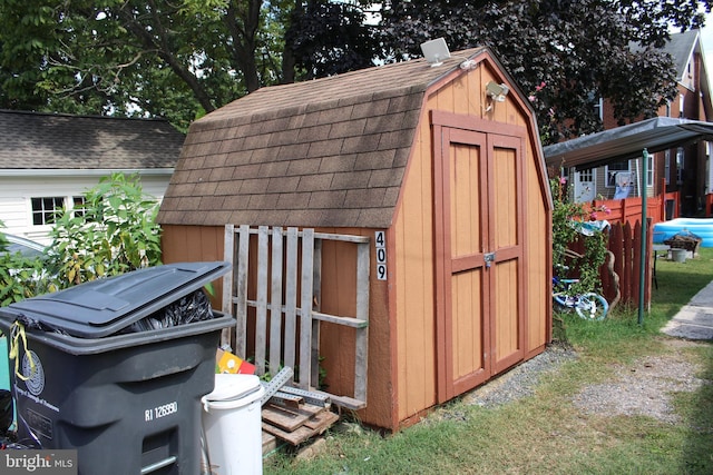 view of shed featuring fence