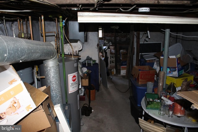 unfinished below grade area featuring water heater
