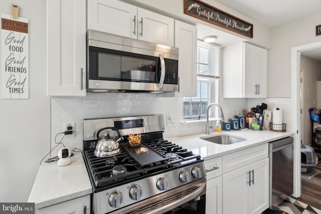 617 Franklin Ave, Cherry Hill, NJ 08002 - kitchen with backsplash, appliances with stainless steel finishes, a sink, and white cabinetry