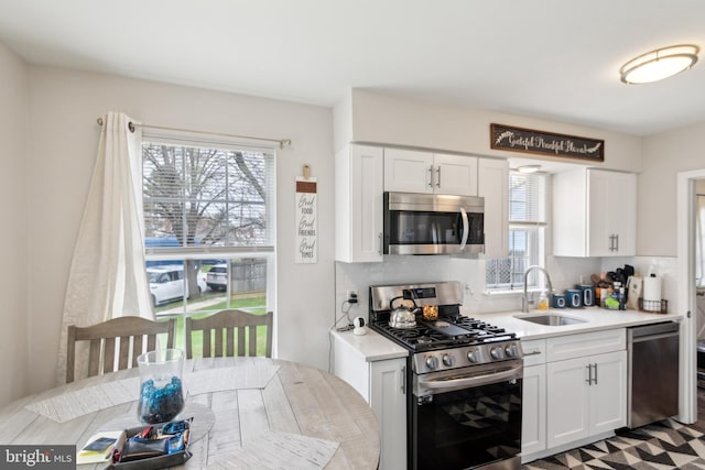 617 Franklin Ave, Cherry Hill, NJ 08002 - kitchen with white cabinets, light countertops, a sink, and appliances with stainless steel finishes