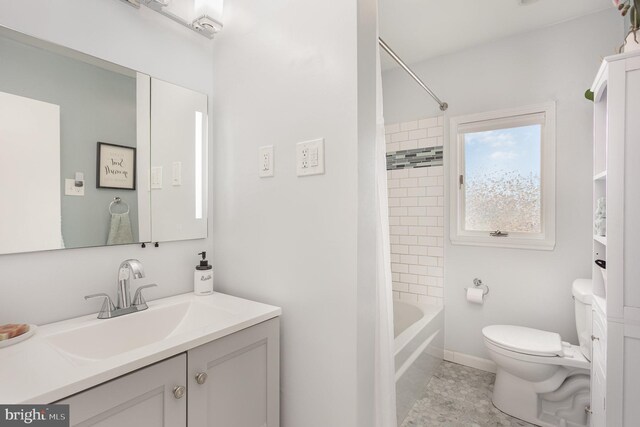 bathroom with toilet, vanity, shower / bath combination with curtain, baseboards, and tile patterned floors