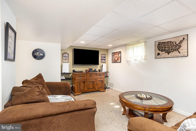 living room with light colored carpet, a drop ceiling, baseboards, and recessed lighting