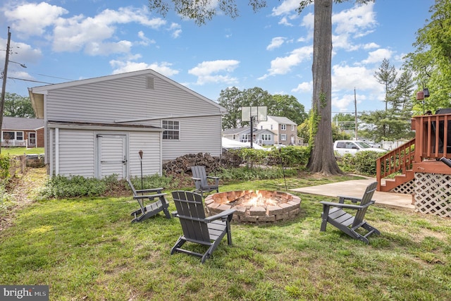 view of green lawn featuring an outdoor fire pit