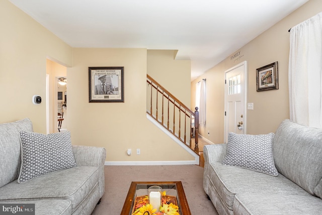 living room featuring stairway, carpet, and baseboards