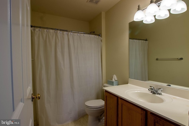 full bathroom with toilet, a notable chandelier, and vanity