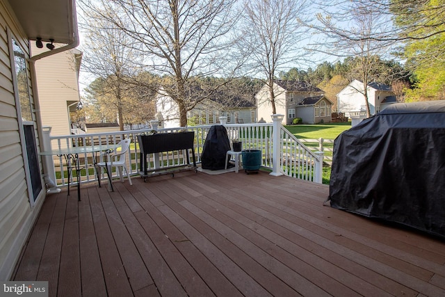deck featuring a residential view and a grill