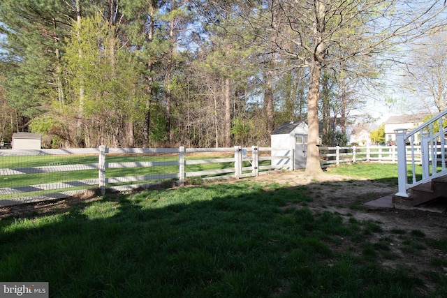 view of yard featuring a fenced backyard, an outbuilding, and a shed