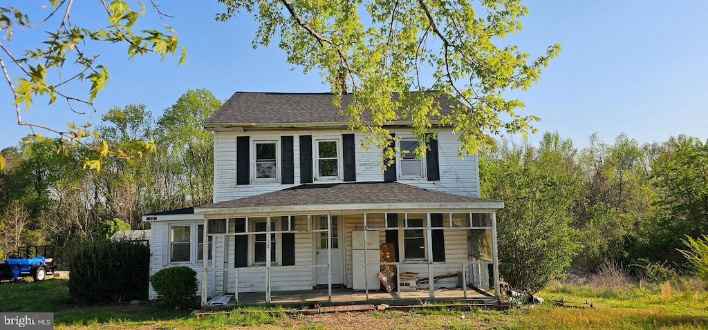 view of front of home with a porch and a shingled roof