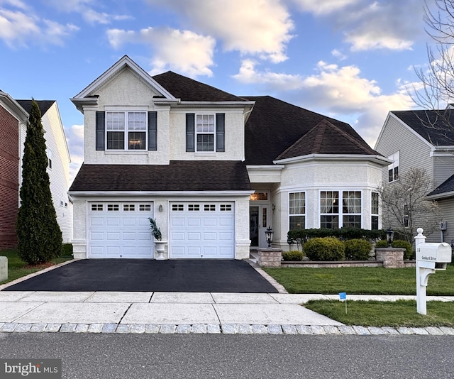 14 Goddard Dr, Cranbury, NJ 08512 - traditional home featuring asphalt driveway, an attached garage, roof with shingles, and a front lawn