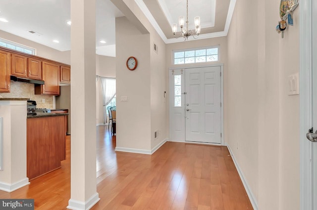 14 Goddard Dr, Cranbury, NJ 08512 - entryway featuring light wood finished floors, ornamental molding, a chandelier, a towering ceiling, and baseboards