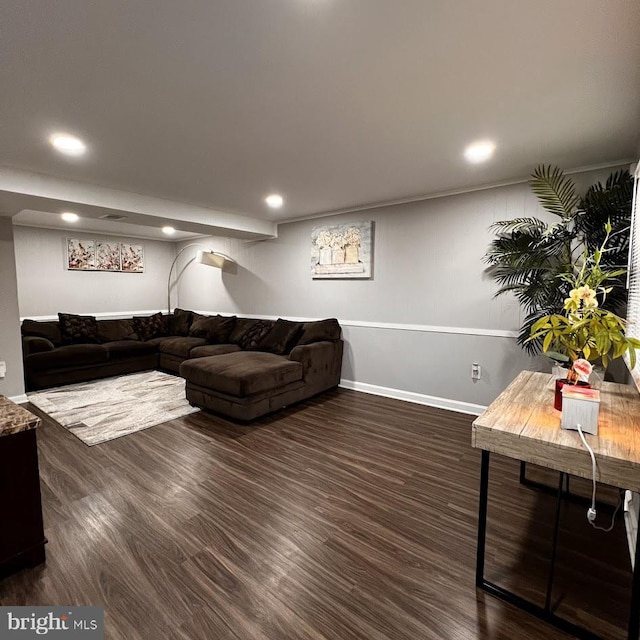 living room with recessed lighting, dark wood-type flooring, and baseboards