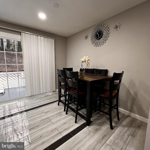 dining area with wood finished floors, baseboards, and recessed lighting