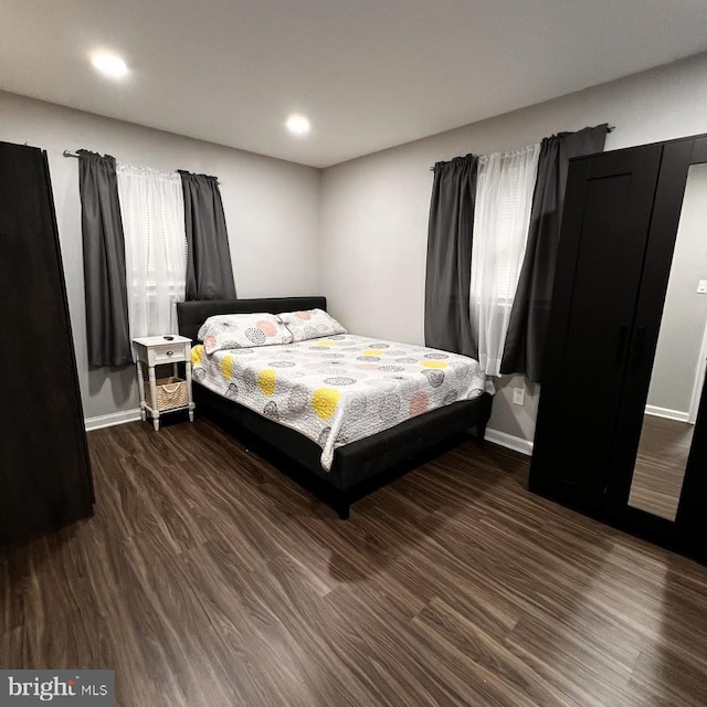 bedroom featuring baseboards, recessed lighting, and wood finished floors