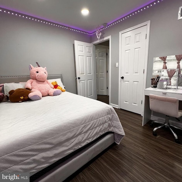 bedroom with wood finished floors, baseboards, and visible vents