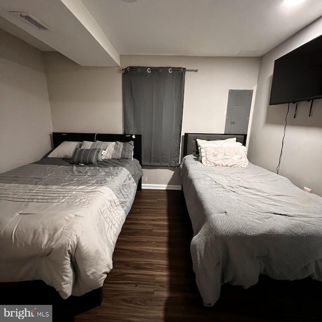 bedroom featuring wood finished floors and visible vents