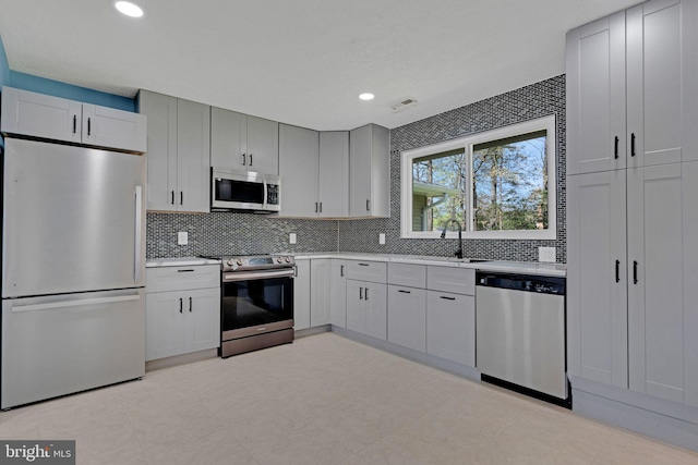 3600 Yorktown Dr, Waldorf, MD 20601 - kitchen with tasteful backsplash, light countertops, a sink, and appliances with stainless steel finishes