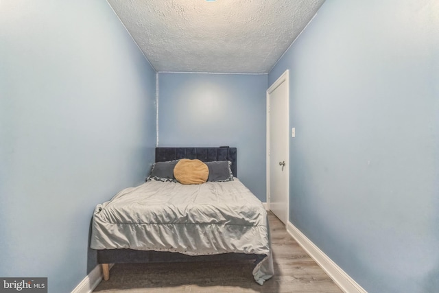 3600 Yorktown Dr, Waldorf, MD 20601 - bedroom with a textured ceiling, baseboards, and wood finished floors