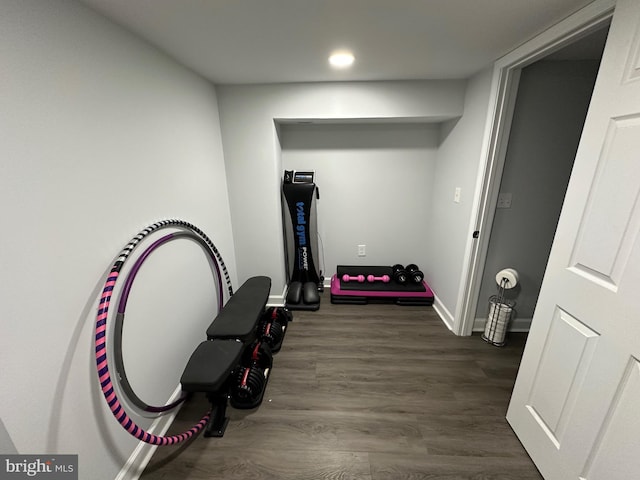 workout room featuring recessed lighting, baseboards, and wood finished floors