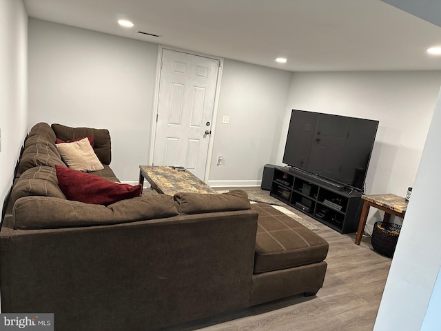 living area featuring recessed lighting, visible vents, baseboards, and wood finished floors