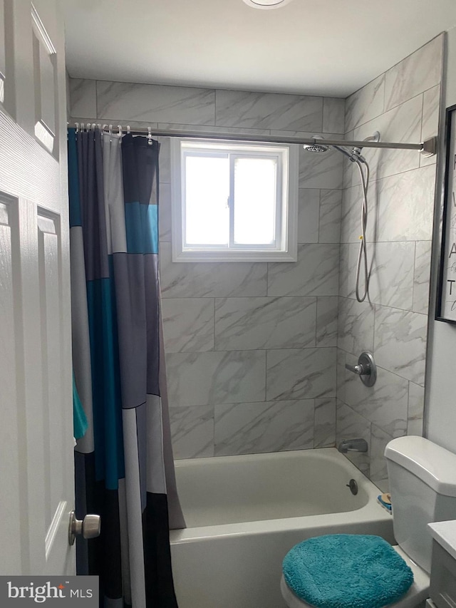 bathroom featuring toilet and shower / tub combo with curtain