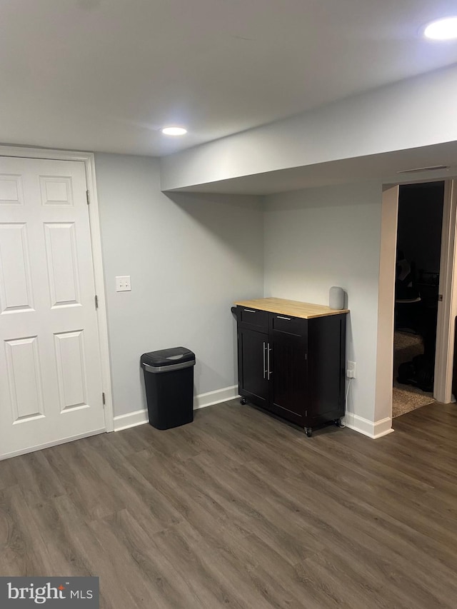finished basement with dark wood-style flooring and baseboards